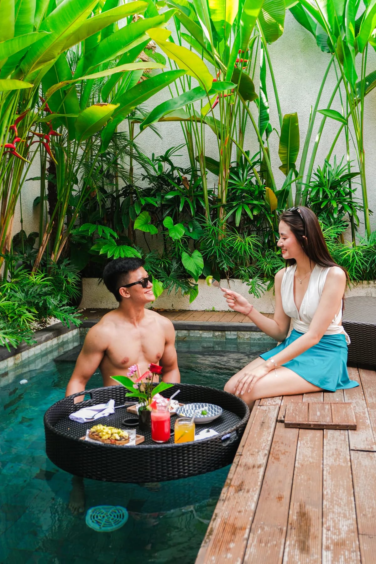Couple beside a private pool with a floating breakfast at Tannari Villas