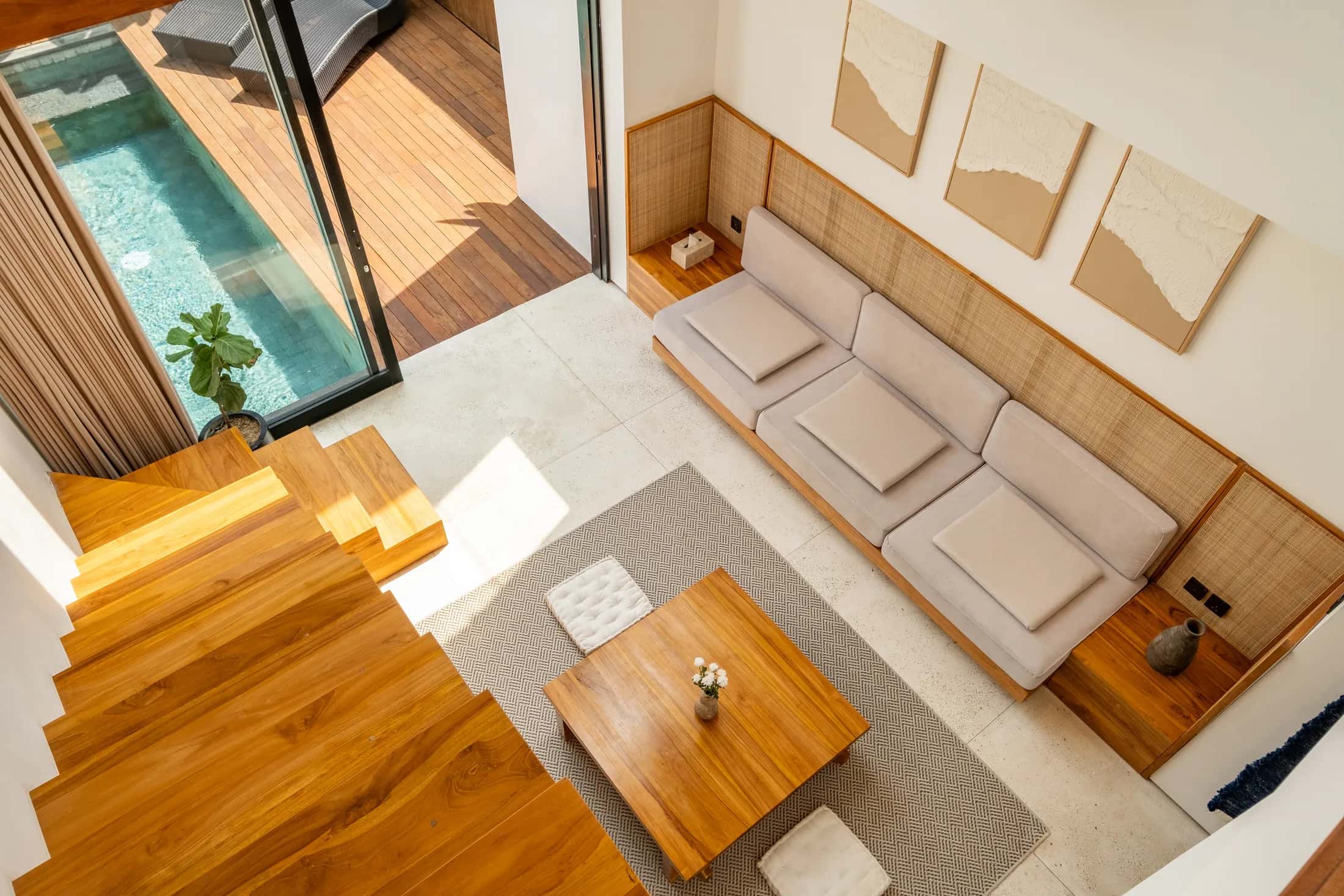 Mezzanine villa loft view looking down to the living room and pool deck
