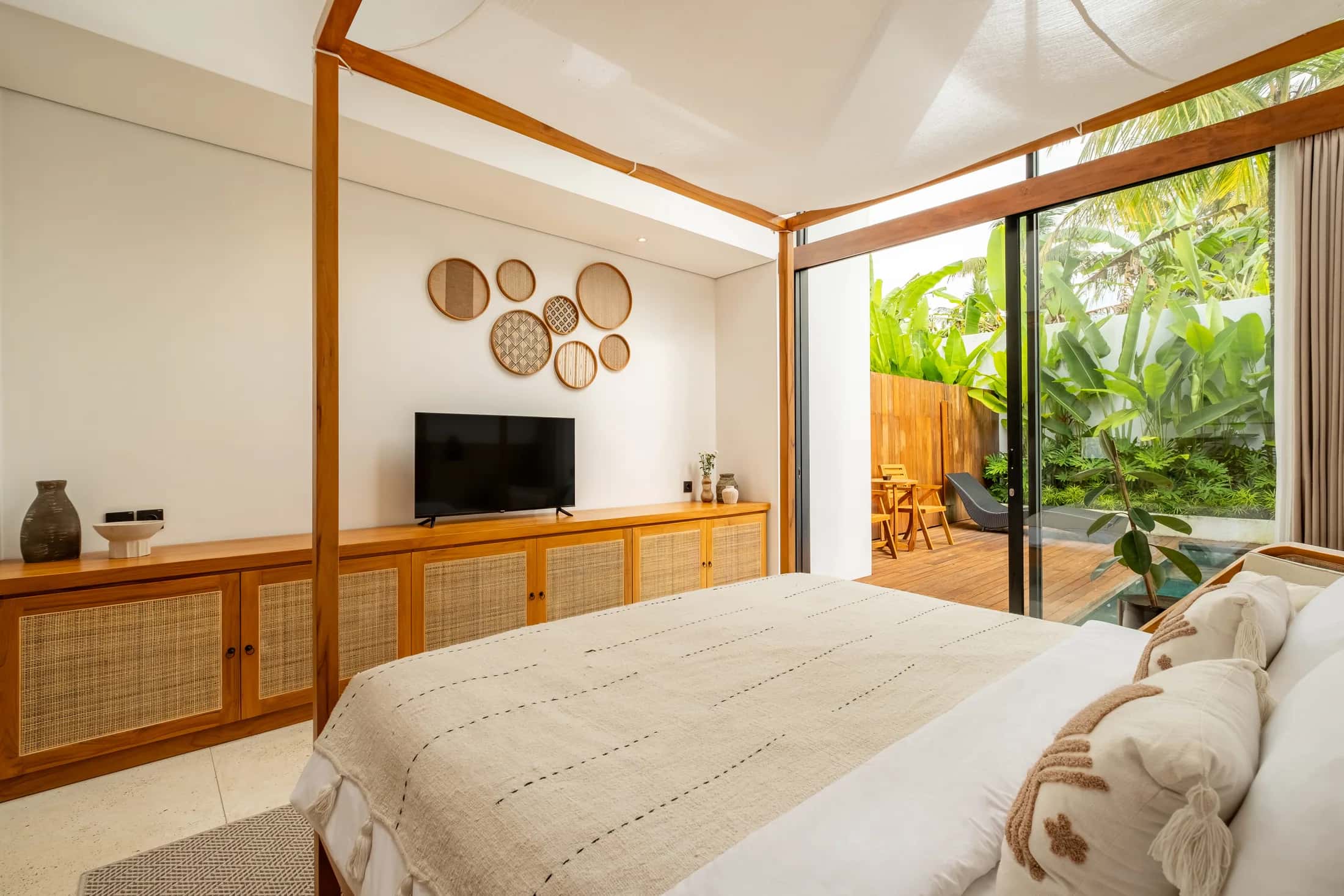 One Bedroom villa bedroom with warm wood details and a wide view of the bed