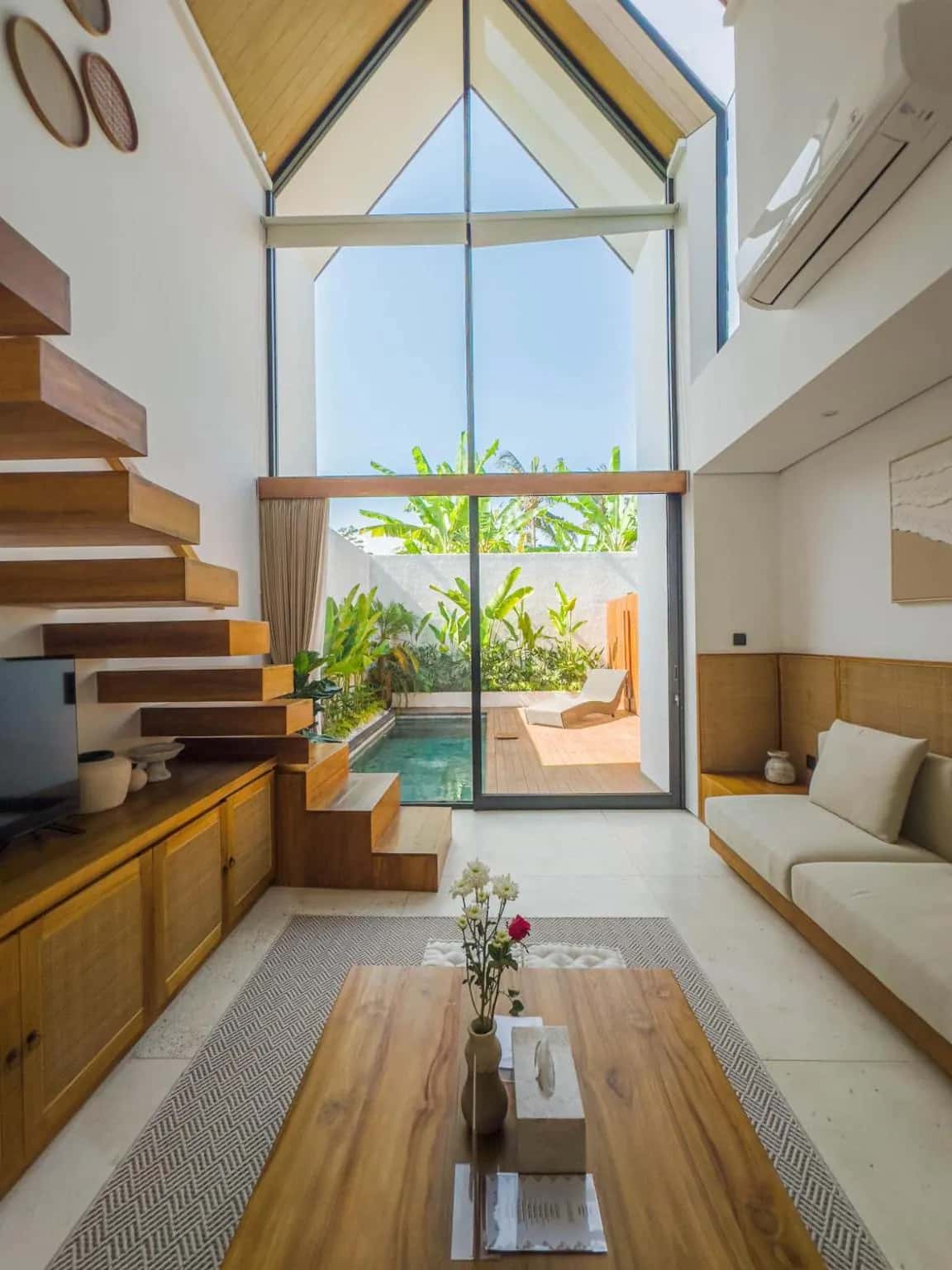 Mezzanine open living room with a large window and pool view