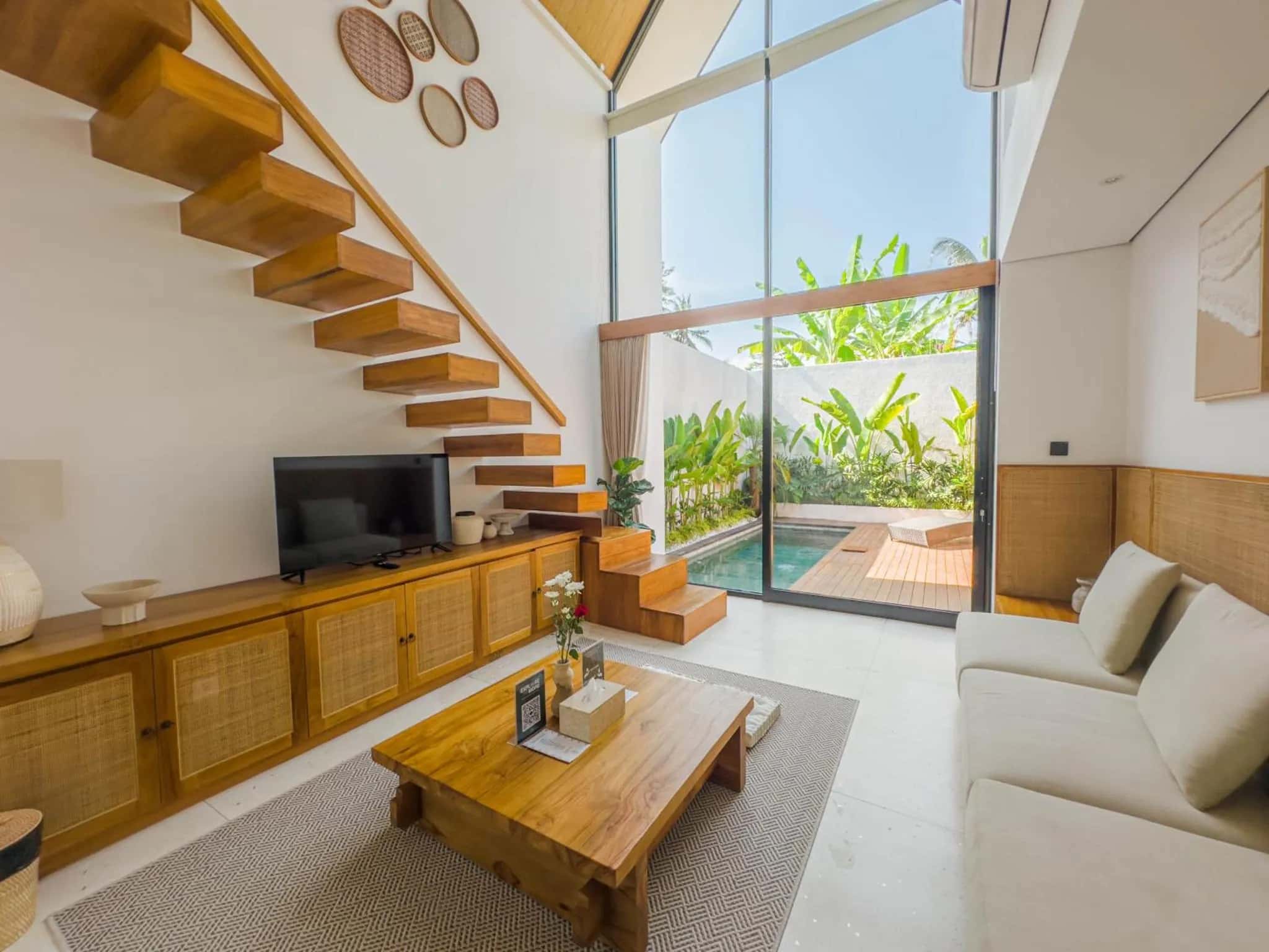 Mezzanine living room with a couch, TV, and table