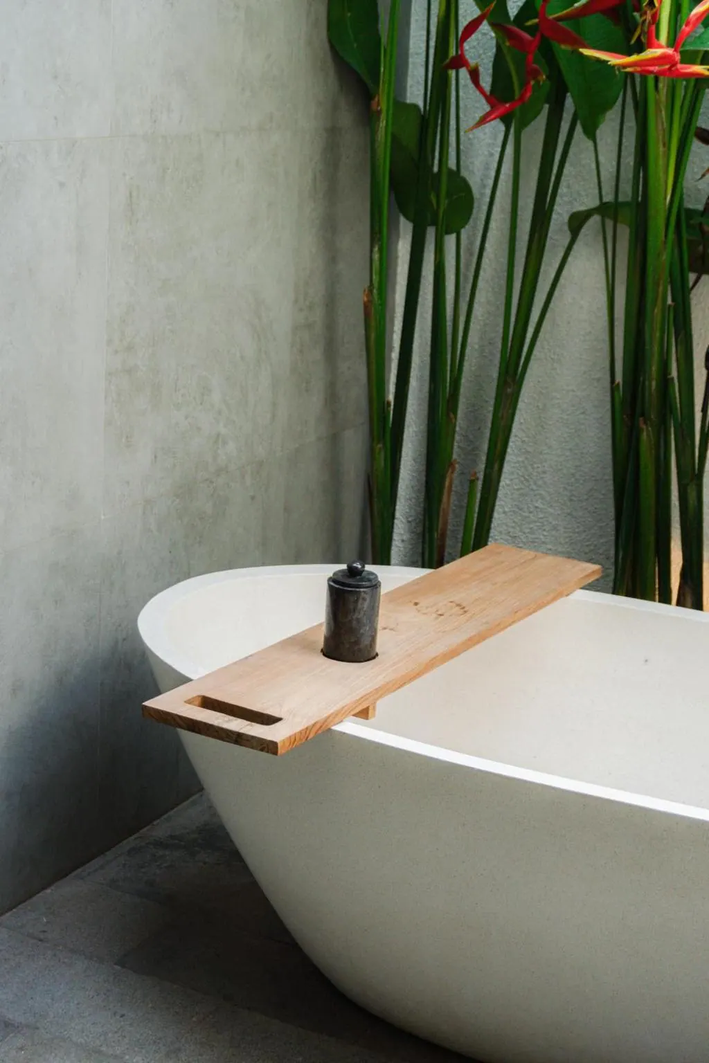 Quiet in-villa wellness setting with a bathtub and tropical plants at Tannari Villas