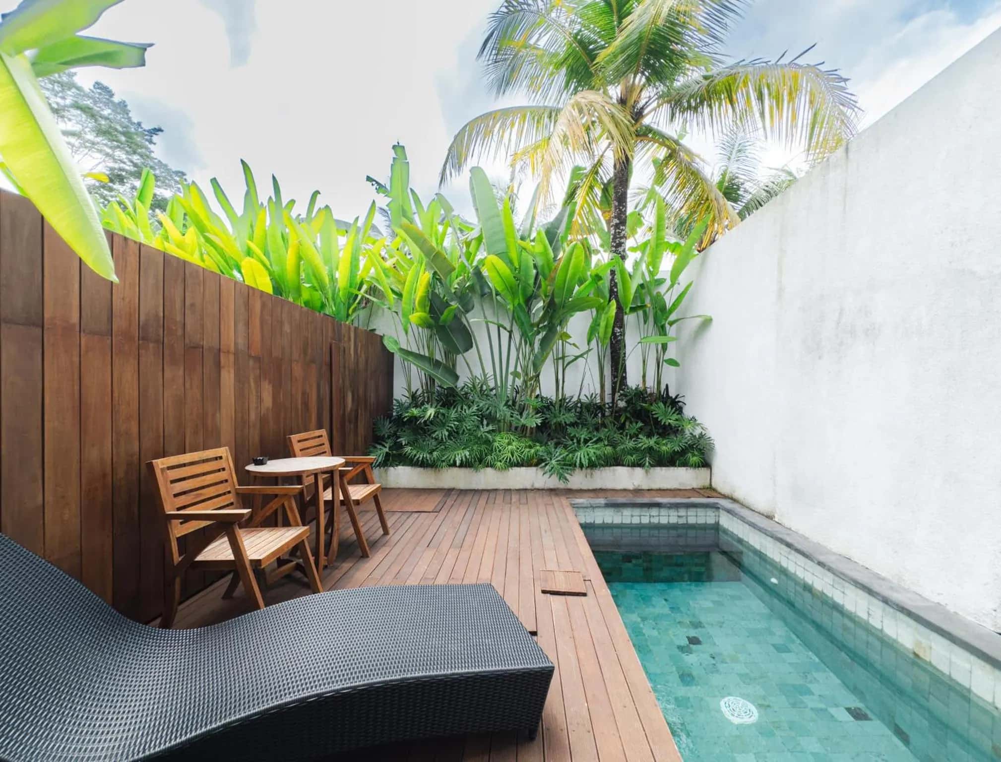 One Bedroom patio with a pool, table, and chairs