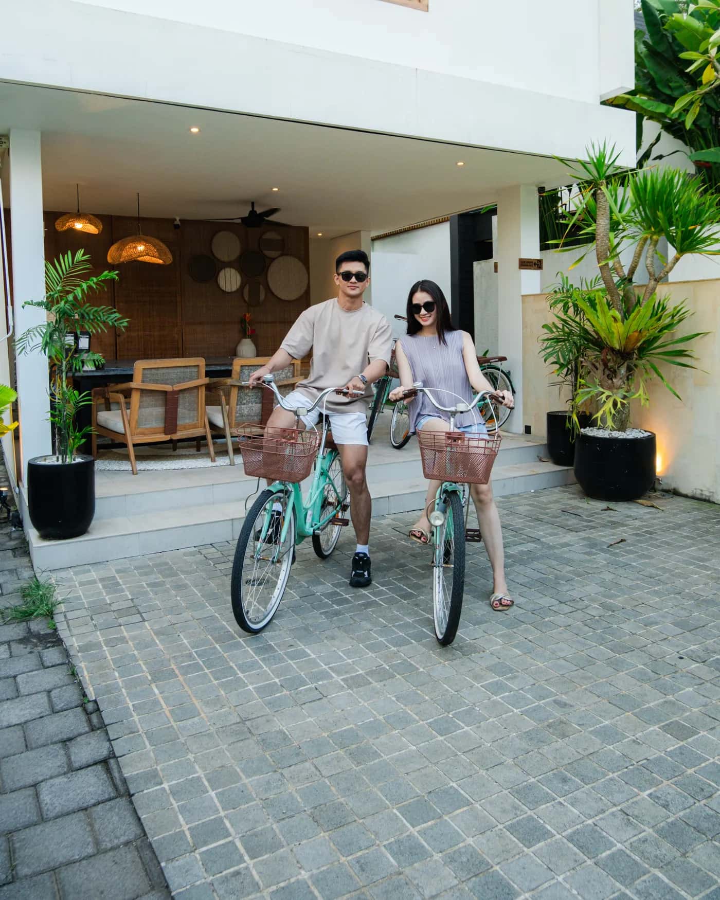 Couple on mint bicycles outside the Tannari Villas lobby